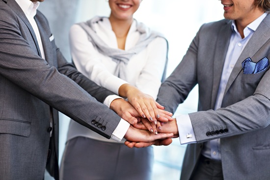 Group of business people sharing ideas in modern office